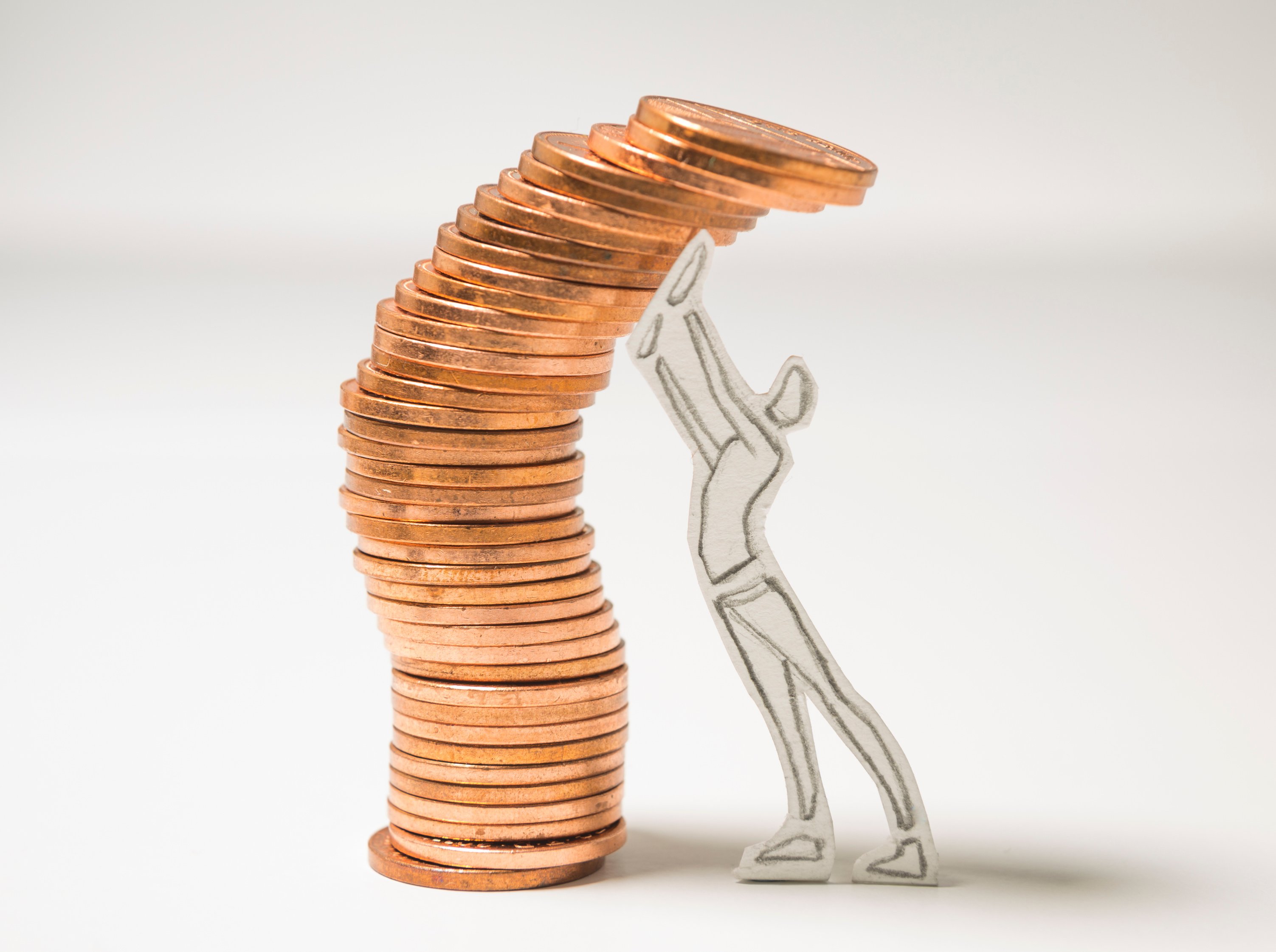 a person reaching up to a stack of coins